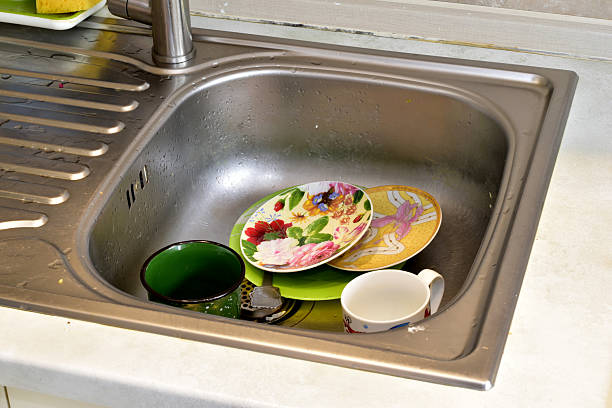 There are dirty dishes in the kitchen sink.