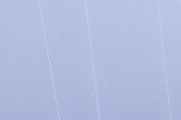High-angle view of layered white textured paper creating elegant diagonal lines and soft shadows. A clean, minimalist abstract background perfect for modern design, stationery mockups, and sophisticated business concepts.