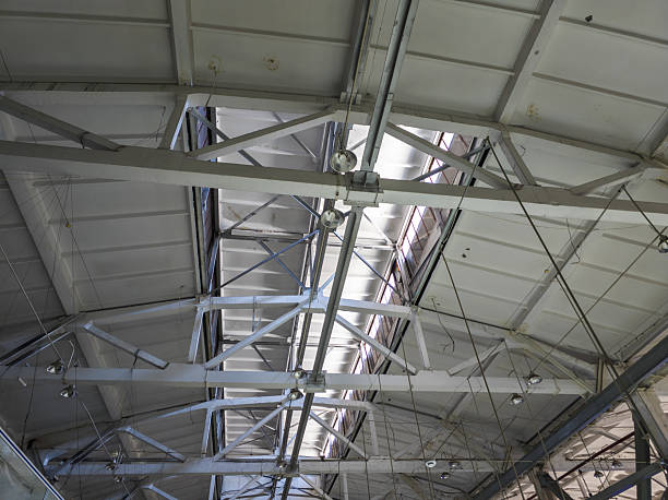 Industrial ceiling with concrete Trusses and Hanging Lights, view from inside