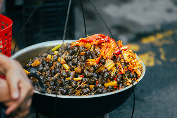 Suckling snails with chili peppers, Traditional Vietnamese food sold on the street.Da Nang - Vietnam.