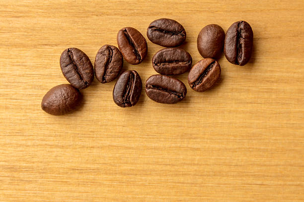 Close-up of coffee beans on a wooden background. Space for copy.