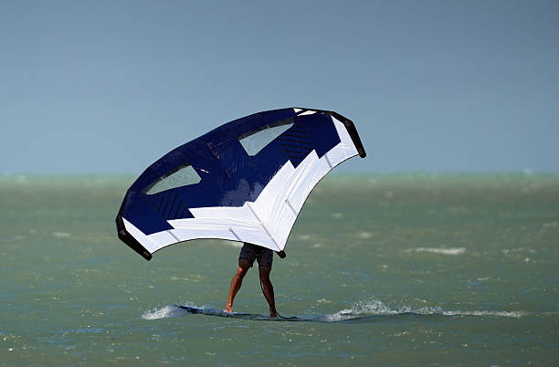 Kite Surfing and Foil Surfing on the Ocean in Florida. Windy days off the beach doing water sports.
