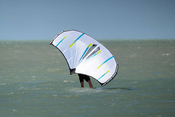 Kite Surfing and Foil Surfing on the Ocean in Florida. Windy days off the beach doing water sports.