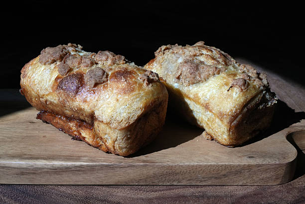 Sour Dough bread, Sandwich Breads and loafs all Family Cuisine made at home. Sweet and Cinnamon Crunchy bread on a cutting board.