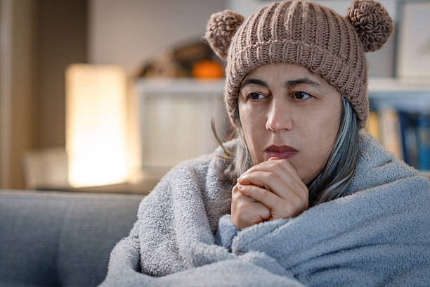 istock Woman feeling cold and shivering at home during winter 2263205220