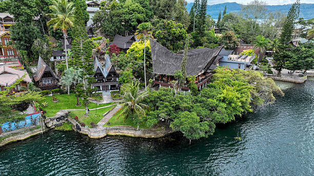 Samosir Islands, Indonesia, September 9, 2025. Batak architecture shines on Samosir peaked roofs, verandas amid coconut groves, lakefront haven on Sumatra.