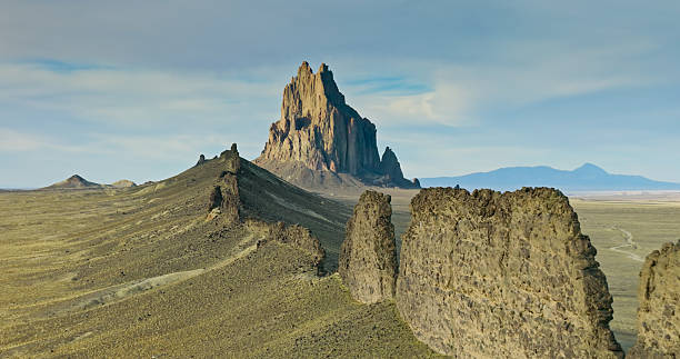Aerial photograph of the dramatic Ship Rock, a 1700-foot tall, 27-million year old volcanic formation in San Juan County, New Mexico. It is a sacred site and plays a significant role in Navajo religion, myth, and tradition.