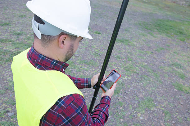 Clever explorer male survey engineer with a surveyor's telescope to explore the construction area to plan road construction with professional tools using the high and low-level cameras of the highway infrastructure.