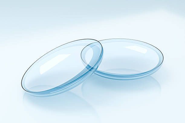 Detailed image of realistic blue contact lenses with soft reflection and visible edge contour. Clean medical aesthetic suitable for ophthalmology presentations, optician branding, contact lens marketing and healthcare promotional materials. Strong commercial concept for vision correction and optical technology themes.
