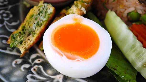 Sliced soft boiled eggs in plate.