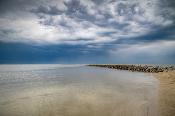 Storm clouds over a dam in the IJsselmeer during a springtime day along the IJsselmeer lakeshore.