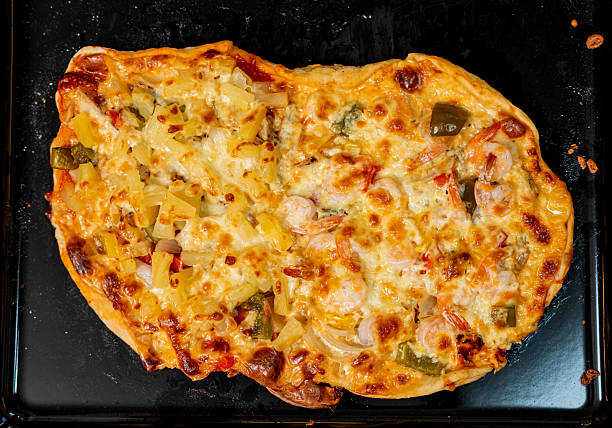 A vertical shot of different delicious pizzas on wooden boards on the table