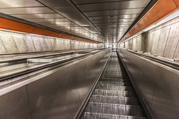 Empty subway escalator in underground metro station with perspective view