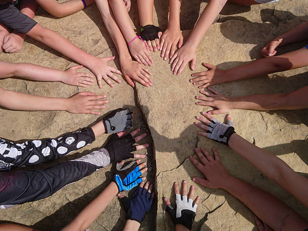 Group view of children's hands as explorers search for hidden objects