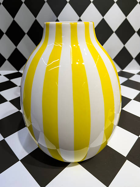 Yellow Striped Ceramic Vase on Black and White Checkered Background​