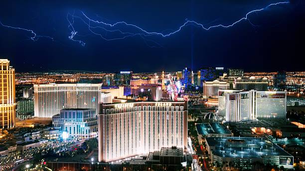 A stunning night view of the Las Vegas Strip illuminated by city lights and dramatic lightning in the sky.