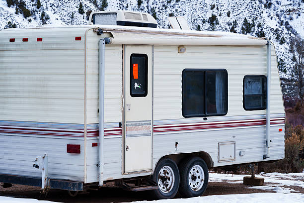 Brown vintage 1980s recreational vehicle broken down along Interstate 90 near Ellensburg, Washington, September 2025. Disabled RV parked roadside in rural landscape.