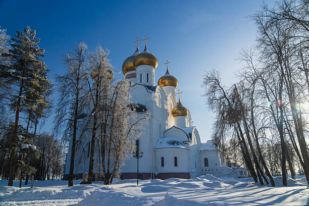 Orthodox cathedral in winter landscape surrounded by snow and trees. Suitable for seasonal and religious background use.