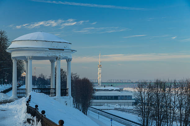 Winter cityscape with snow-covered park and distant river under soft sky. Suitable for seasonal and urban background use.