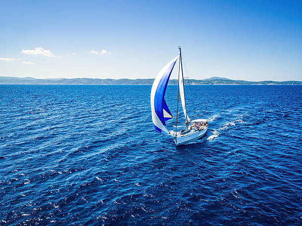 Sailboat during sailing. High angle view from drone. Model released.