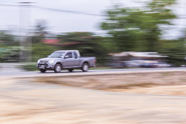 pick-up Speeding in road, pan camera