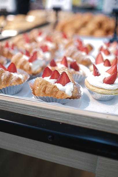 A tray of pastries with strawberries on top