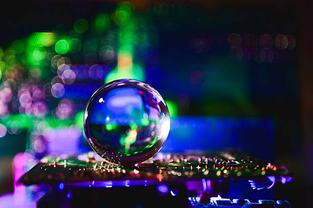 Crystal ball resting on a circuit board, reflecting glowing bokeh lights, visualizing future tech