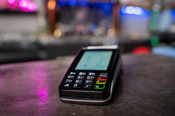Close up of payment terminal on bar counter.