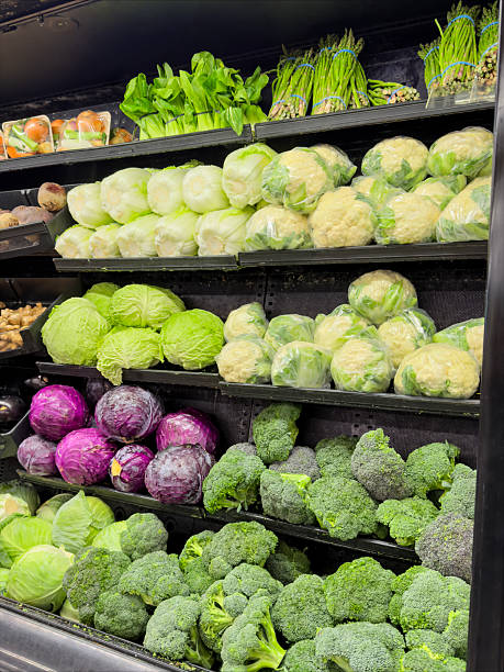 Fresh green vegetables on supermarket produce shelves in grocery store.​