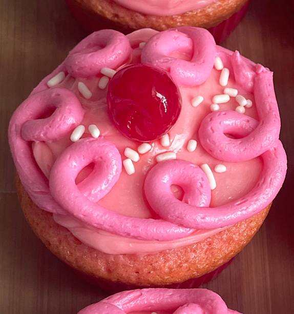 A delightful cupcake topped with rich frosting and decorative sprinkles. Perfect for dessert photography, showcasing the charm and sweetness of baked goods, ideal for parties and celebrations.