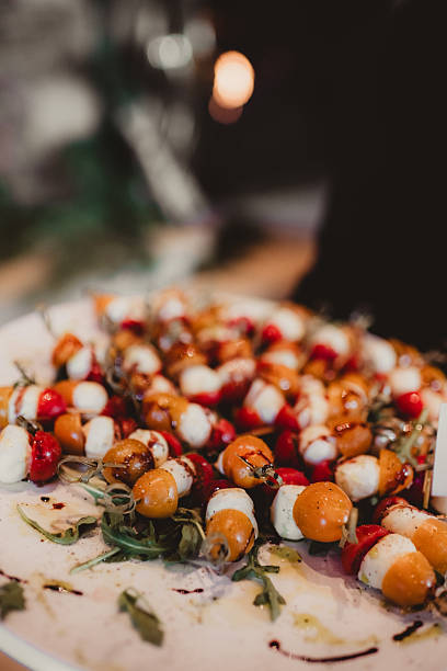 Mozzarella and tomato caprese skewer appetizers on a serving tray