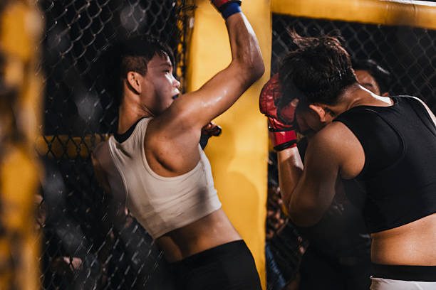 Female MMA fighters compete in local competition, elbow.