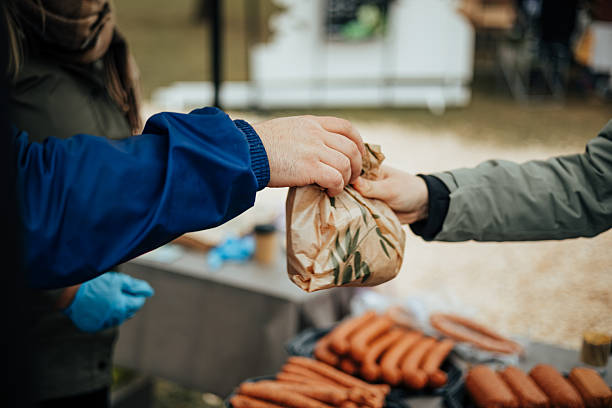 Food Purchase at Local Market with Sausage Stall
