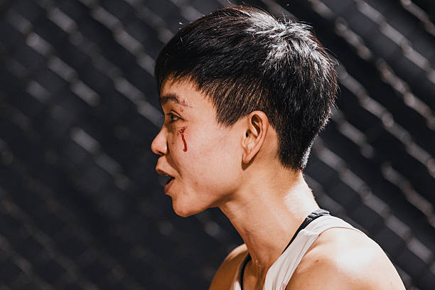 Female fighter shows determination during training session after facing a tough challenge in the gym