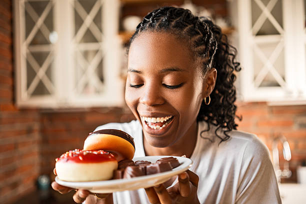 A bitten doughnut with berry filling on a white background. one decorated chocolate covered doughnut. selective focus