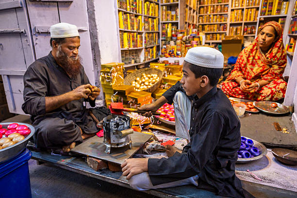 Whole family working in the bangle shop in Jaipur. During Holi festival they stop making colorful bangles and start preparing Gulaal Gotas. Gulaal Gota is a lac ball filled with gulal powder. These \
