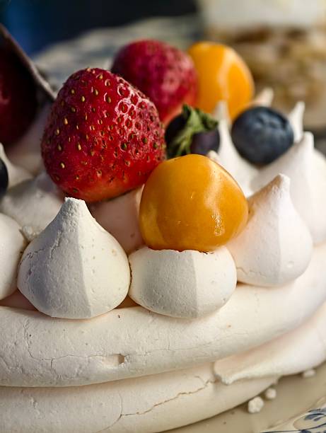 Close-up of Pavlova Dessert with Fresh Strawberries, Physalis, and Blueberries