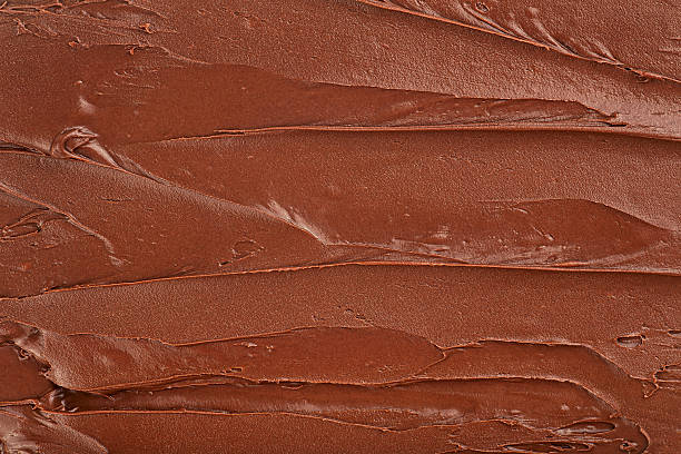 Melted chocolate cream as background, top view. Hazelnut cream, chocolate smear.