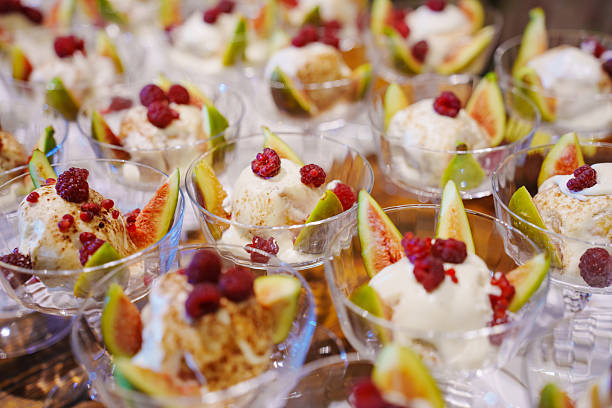 Delicious ice cream desserts with fresh fruits at a summer gathering