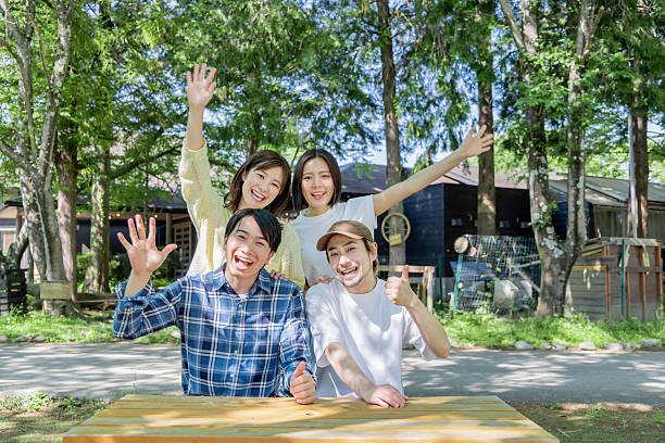 Asian group relaxing at camping facility