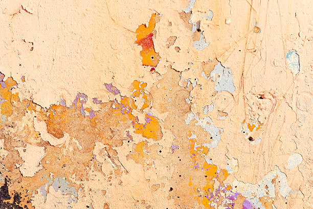 light brown painted concrete wall that has cracks and paint flakes in different colors and can be used for backgrounds and decorations and idea images from benidorm in Spain
