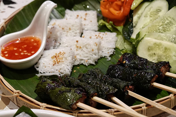 Grilled Pork Wrapped in Betel Leaf serving in restaurant. Vietnamese food recipes