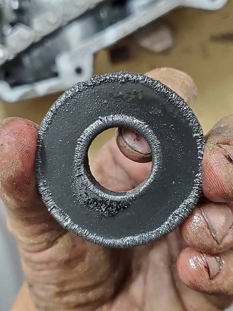 Dirty Hand Holding the Magnet from a Transfer Case, Working on Car. High quality photo