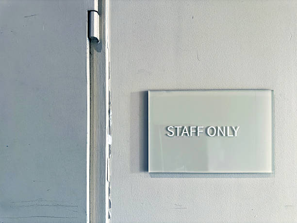 Warning sign attached on wall at doorway