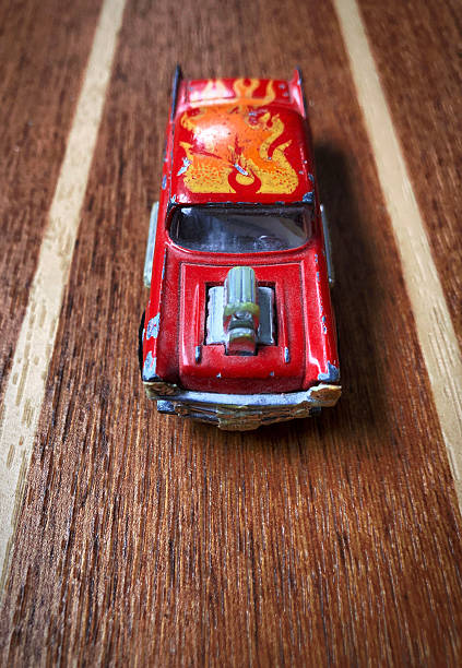 Beat up red hot car on a race track