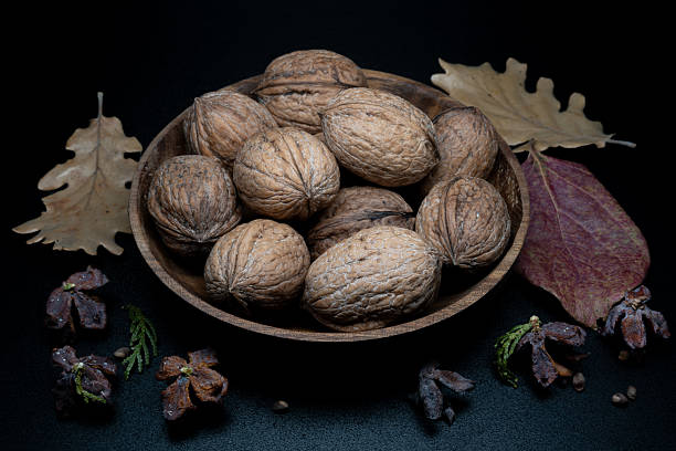 A composition of typically autumnal fruits such as walnuts, enhancing their beauty and detail
