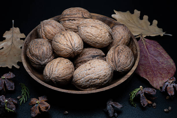 A composition of typically autumnal fruits such as walnuts, enhancing their beauty and detail