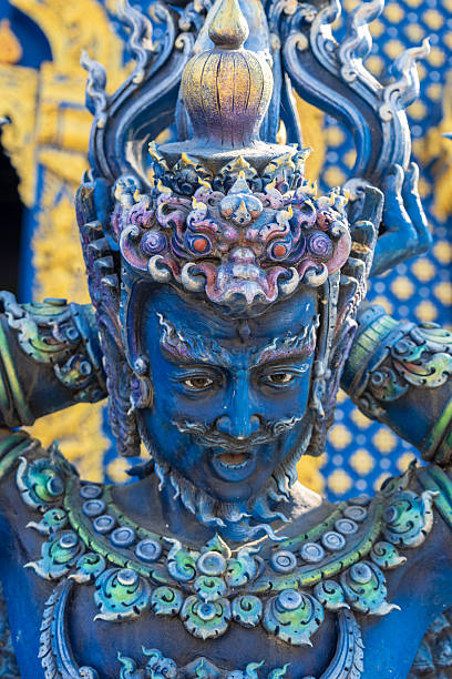 Chiang Rai, Thailand - January 30, 2026: Close-up of an ornate cobalt guardian statue at Wat Rong Suea Ten (Blue Temple), showcasing intricate Thai Buddhist artistry with golden and purple details.