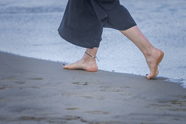 Young woman is walking on the beach near by the sea.My Kea Beach, Da Nang - Vietnam.