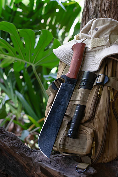 machete knife and a hiking backpack rest on a log.